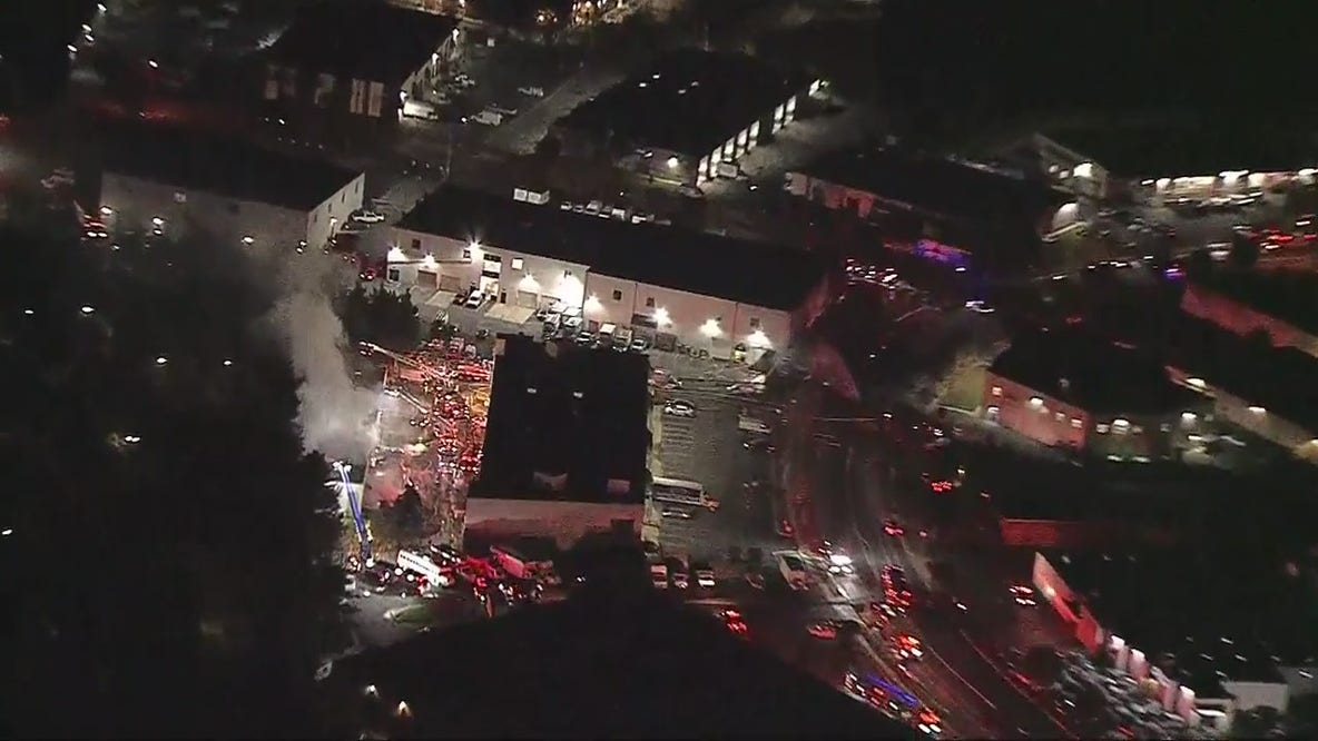 Firefighters battle smoke, flames to control 2-alarm fire at Rockville auto body shop, laundromat